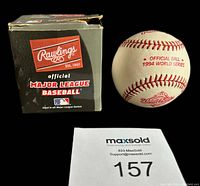 Photo of the official 1994 World Series baseball alongside the original Rawlings box and MaxSold lot tag.