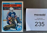 Front of Grant Fuhr 1982-83 OPC rookie card #105 showing the player in Oilers uniform, goalie pads, and helmet.