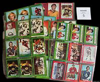 Lot of 85 1973-74 O.P.C. hockey cards laid out showing front side of cards with various players, including duplicates.