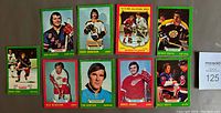 Photo of 10 individual hockey cards laid out on table including players Brad Park, Rex Gilbert, Derek Sanderson, Bobby Clarke, Johnny Bucyk, Alex Delvecchio, Tim Horton, Marcel Dionne, and Billy Smith.