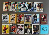 Top view of multiple signed NHL hockey cards arranged in two rows showing player images and autographs in blue and black ink.