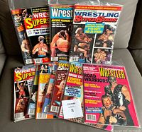 Photo of 12 classic wrestling magazines from 1984-1989 with colorful covers and some in protective bags.