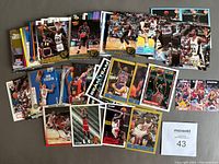 Photo showing a large spread of approximately 150 basketball cards from 1990-1995 including several Michael Jordan cards.