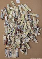 Multiple personalized pens in original packaging spread out on a flat surface.