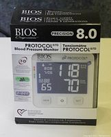 Front view of BIOS Diagnostics Protocol 7D Model 8.0 blood pressure monitor box. Shows product name, model, and a picture of the device's digital screen.
