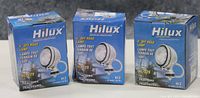 Three new Hilux boxed off road lamps, front view showing box graphics and model info HL-329