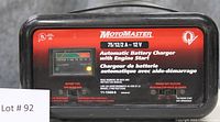 Front image of MotoMaster automatic battery charger showing model and specifications: 75/12/2A, 12 Volts, with engine start feature and analog charge meter.
