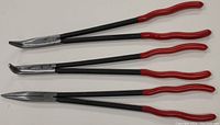 Full view of the set of three 16-inch needle nose pliers with red handles and black shafts, showing one straight, one 90-degree bent, and one angled plier.
