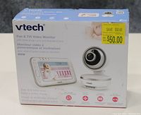 Front view of the original box showing VTech branding, product image, features like wide angle lens and pan & tilt function, and price sticker.