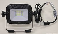 Front view of the Volt King LED worklight showing the LED grid and part of the adjustable stand and power cord.