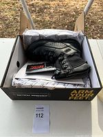 Box containing black tactical boots, size 10, showing the box with Tactical Research branding and slogan 'ARM YOUR FEET'
