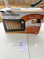 Photo of the electric radiant heater in its original packaging box, showing front image and features.