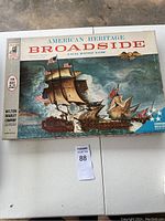The closed game box showing the American Heritage Broadside title with naval battle artwork on the lid