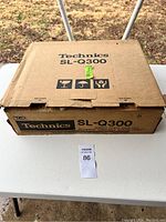 Original cardboard box for the Technics SL-Q300 turntable showing the brand name, model, and shipping symbols.