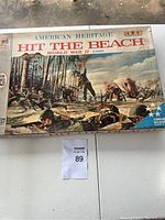 Game box front with colorful WWII battle scene artwork with title 'Hit The Beach'
