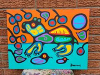 Full front view of the painting against brick wall on floral cloth