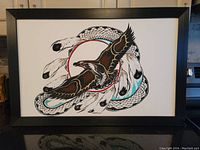 Framed painting showing eagle in flight with snake and feather motifs, overall view
