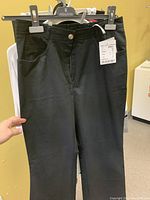 Black women's pants on hanger showing front view and tag