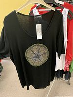 Black short-sleeve top with rhinestone design on front, size XL, brand Don & Stickel with attached tags.
