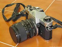 Front-angle view of Pentax Spotmatic SP II with Tamron 35–70 mm lens mounted and attached leather strap