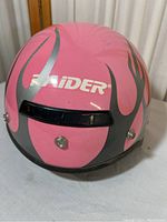 Front view of pink and silver Raider helmet showing branding and vent details