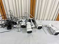 Five Firstrend security cameras laid out with cables and power adapters for visual inspection.