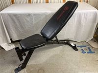 Full side view of the black Marcy adjustable weight bench showing overall structure and padding condition.