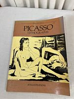 Front cover of the Picasso Lithographs book showing a lithographic illustration of two nude figures and the book title.