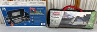 Lot includes Coleman Deluxe propane stove in original box and Coleman Highline II tent in carrying bag.