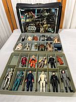 Full view of black Kenner Star Wars collector’s case open, showing two grey trays filled with figures
