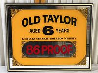 Full front view of vintage Old Taylor whiskey sign showing all text and decorative elements