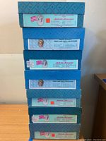 Stacked original blue Madame Alexander boxes for First Lady Doll Collection showing product labels.