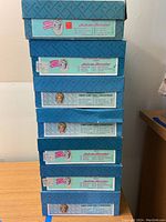 Stack of 8 original Madame Alexander doll boxes showing box labels and logos
