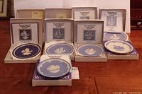 Collection of Wedgwood blue and white jasperware plates from 1971 to 1978 in original boxes with labels.