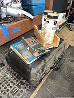 Photo of DeWalt plate joiner tool case with accessories and joiner discs on top.