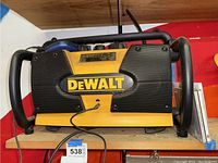 Dewalt radio showing front view with yellow and black body, side handles, and mesh speaker grills.