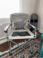 Front view of one LL Bean EZ Comfort camp chair showing mesh seat and back, and padded armrests with tubular frame.