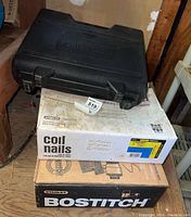 Porter-Cable carry case on top of Stanley Bostitch coil nails and Bostitch box