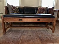 Overall front elevation of bench against backdrop of sofa