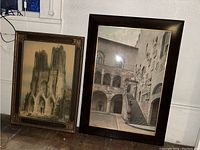 Two framed architectural wall art prints side by side on the floor, showing overall size and visual style.