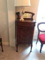 Front view showing single drawer over cabinet door and beveled mirror backboard