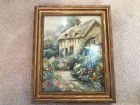 Front view of the framed watercolor painting showing a thatched roof cottage and flower garden.