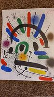 Full view of Joan Miró style lithograph showing abstract colored shapes and black splattered dots.