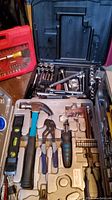 Craftsman socket set with hammer, pliers, screwdriver bits, level in an open plastic case