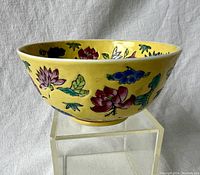 View of the yellow famille jaune porcelain bowl showing the floral painted design on outside