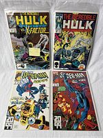 Four comic books including two The Incredible Hulk vs. X-Factor and two Spider-Man 2099 issues in protective plastic sleeves.