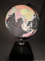 Black Starlight globe lit up showing Asia and Australia with dated political boundaries.