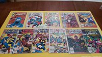 Photo of 11 Captain America comic books arranged in two rows, showing front covers with colorful vintage comic art, featuring Captain America and other characters.