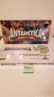 Front view of Antarctica Global Warming board game box with illustrated characters and map of Antarctica.