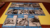 15 Model Railroader magazines from 1951 and 1952 arranged in 3 rows on a yellow table, showing various cover photos related to model trains and model railroad layouts.